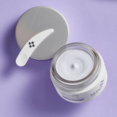 Neova Creme de la Copper jar on purple background